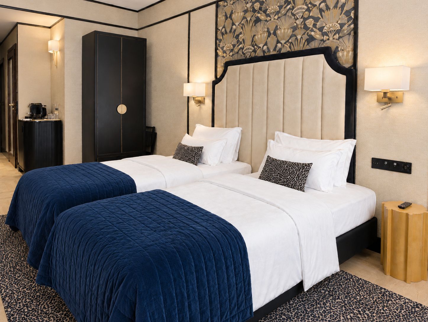 A hotel room with a large bed, two bedside tables, a wardrobe, and a mirror.
