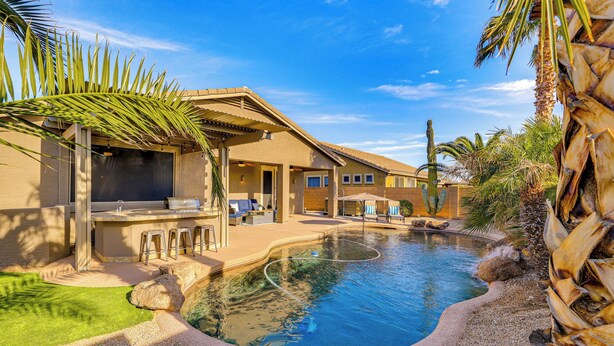A pool area with a pergola, lounge chairs, and a barbecue setup. - Hot Tub & Heated Pool: Home in Estrella Mtn Ranch (Goodyear)