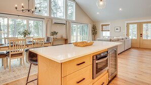 A spacious kitchen with a large island, wooden cabinets, and a built-in oven. - Dock & Game Room: New Waterfront Home in Lyman! (Alfred)