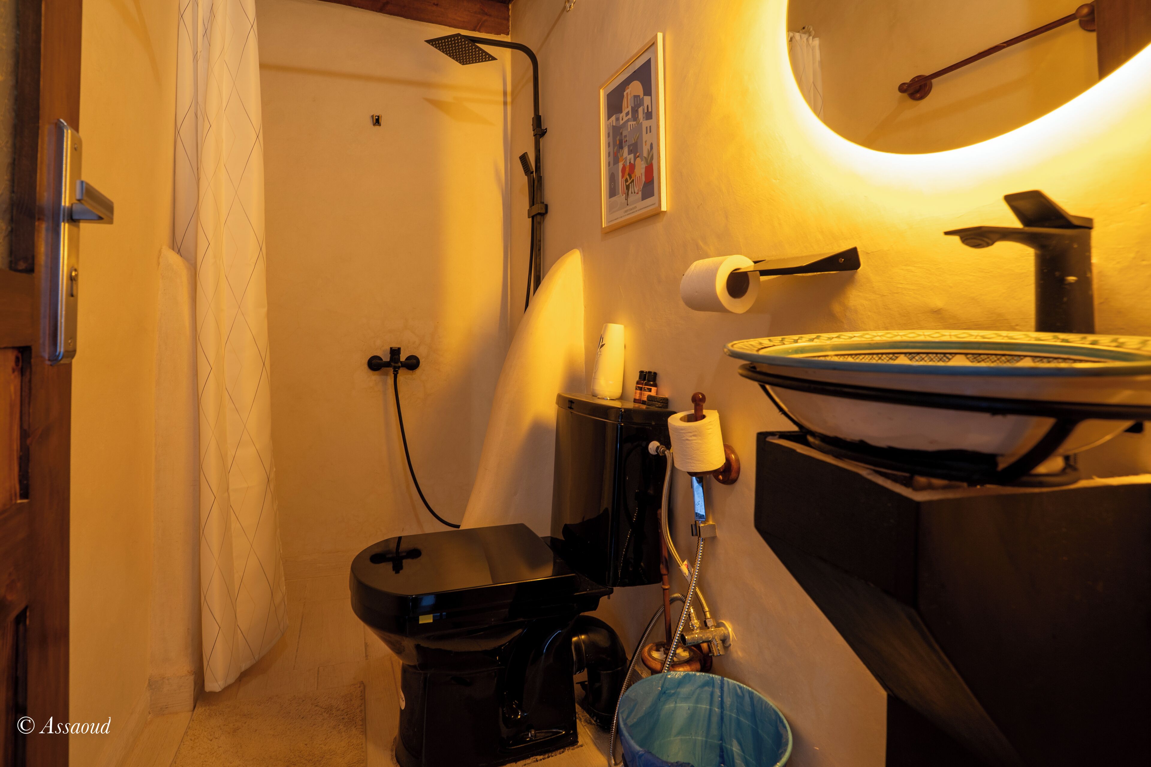 A compact bathroom with a toilet, bidet, and sink.