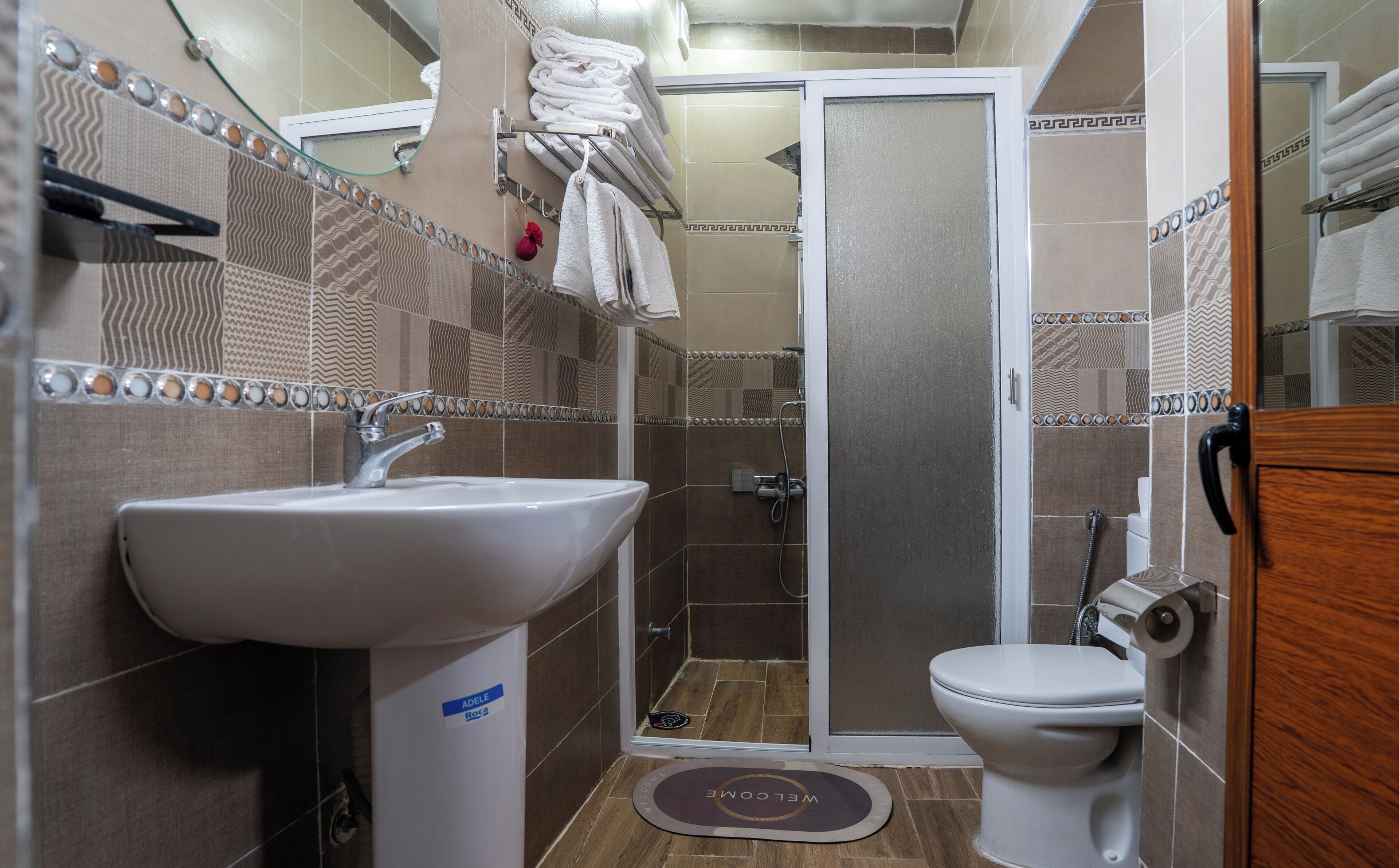A bathroom with a sink, toilet, and shower.