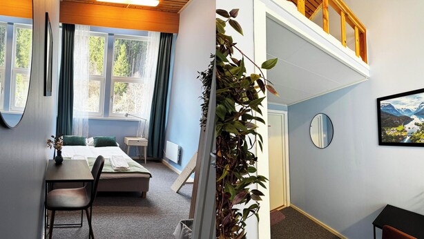 A bedroom with a bed, bedside table, chair, and a view of trees through the window. - Eidsdal Hotel & Restaurant As (Eidsdal)