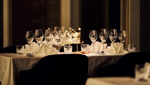 A table set for a meal with multiple wine glasses, water glasses, and cutlery. - Balder Luxury Lodge & Glass Igloos (Kittila)