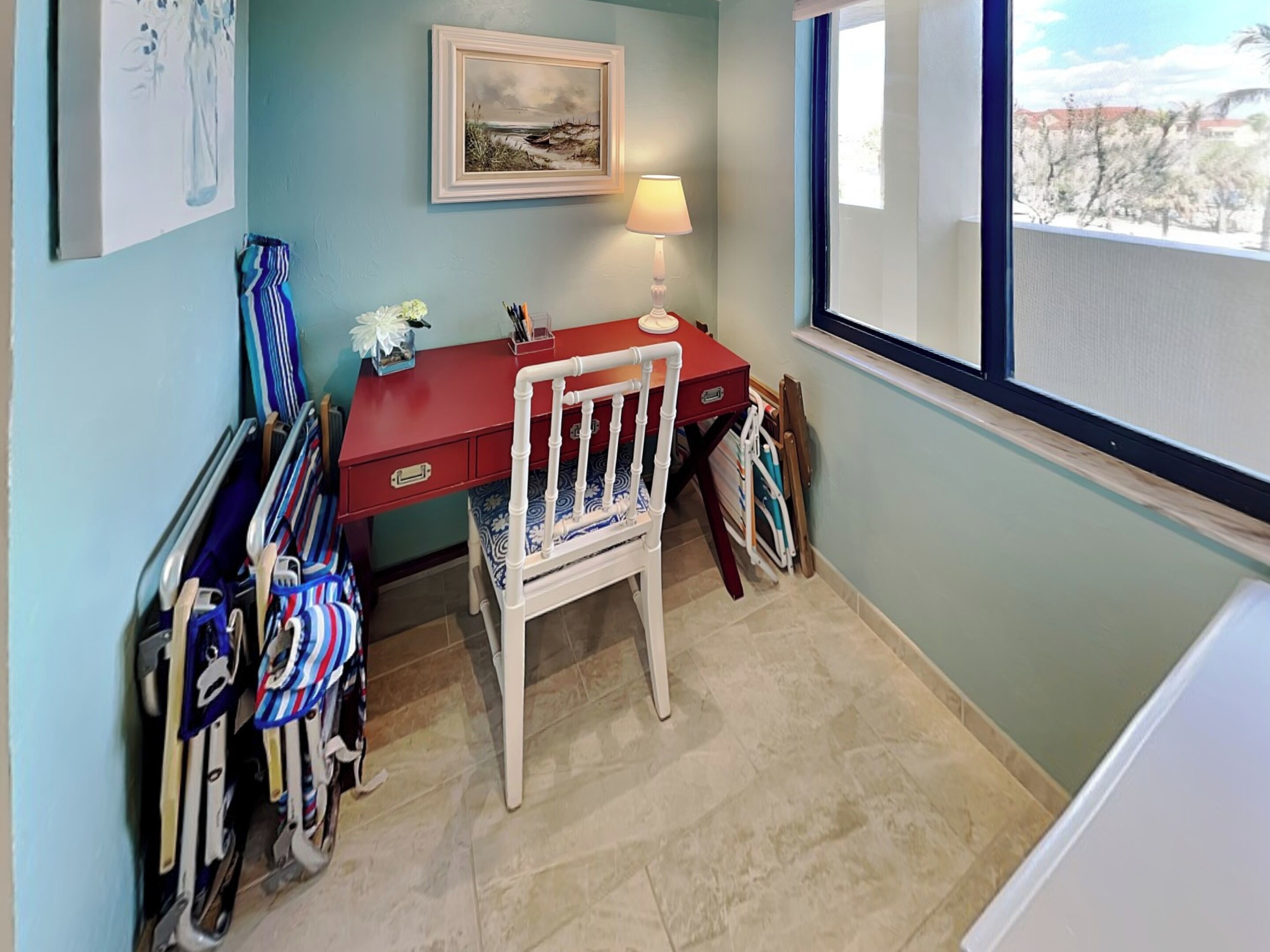 A room with a desk, a chair, and a window.