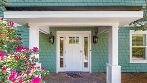 A house with a green exterior, a white front door, and a brick pathway leading to the entrance. - Private Pool! Serene 4/4 Sleeps 14! (Santa Rosa Beach)