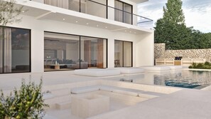 A modern house with a pool, outdoor seating, and a stone wall. - Bougainvillea Essence Villa (Zakynthos)