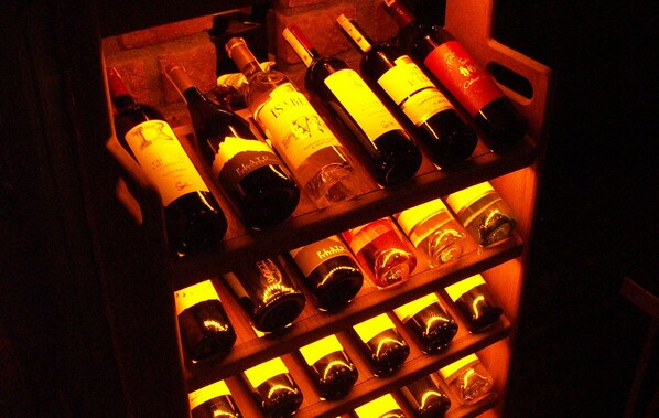 A wine rack with multiple bottles of wine.