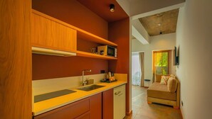 A compact kitchen with wooden cabinets, a microwave, and a sink.