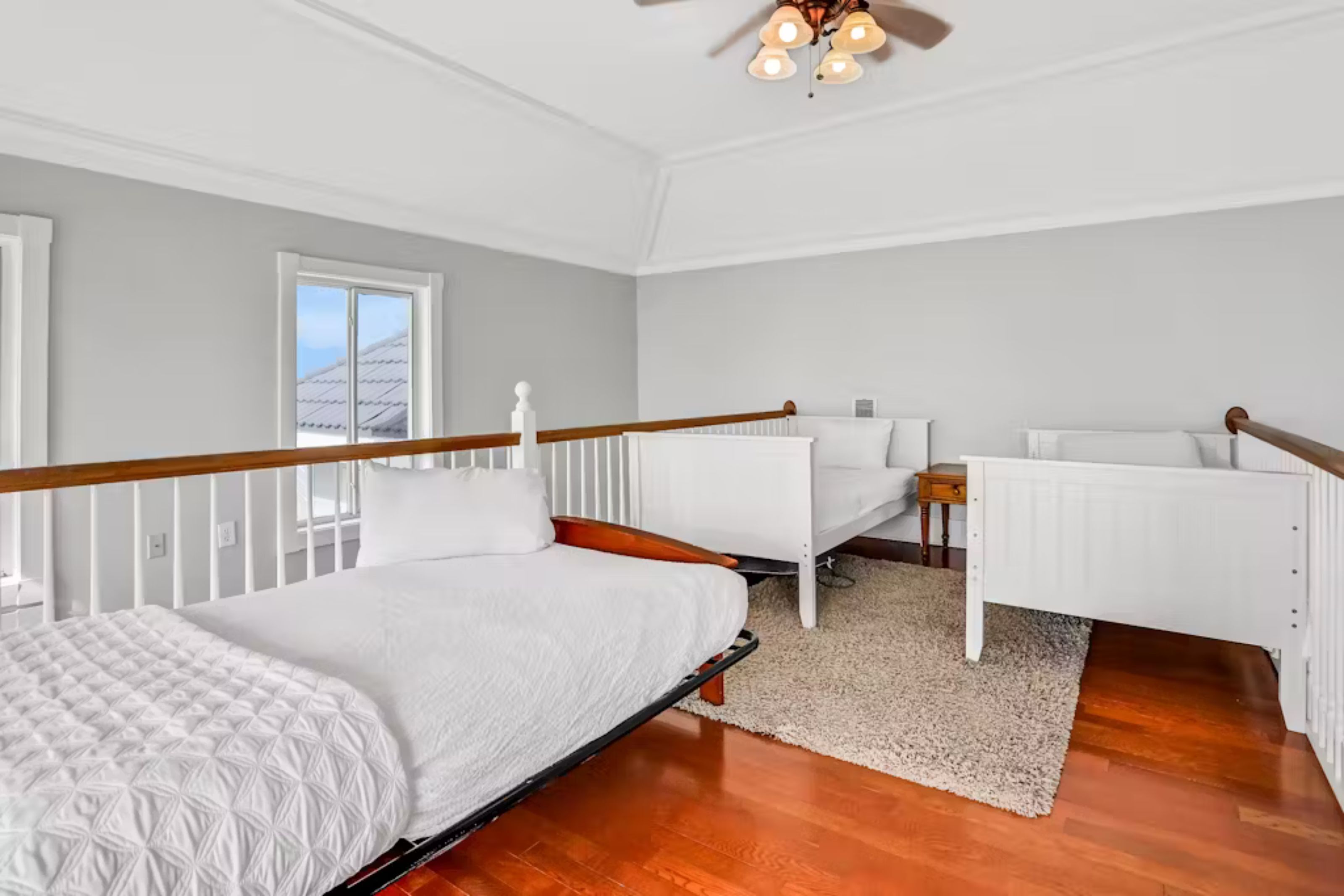 A bedroom with a bed, a desk, and a chair.