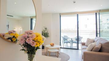 One Bedroom With Balcony and City Views | Living area | 55-inch TV with cable channels