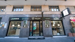 A hotel facade with multiple businesses including 'Claparent', 'Infopoint turistico', 'Clapa Group', and 'torrefa'. - P.C. BOUTIQUE H. LIFESTYLE NAPOLI CENTRO by ClaPa Group Dislocated Hospitality (Naples)