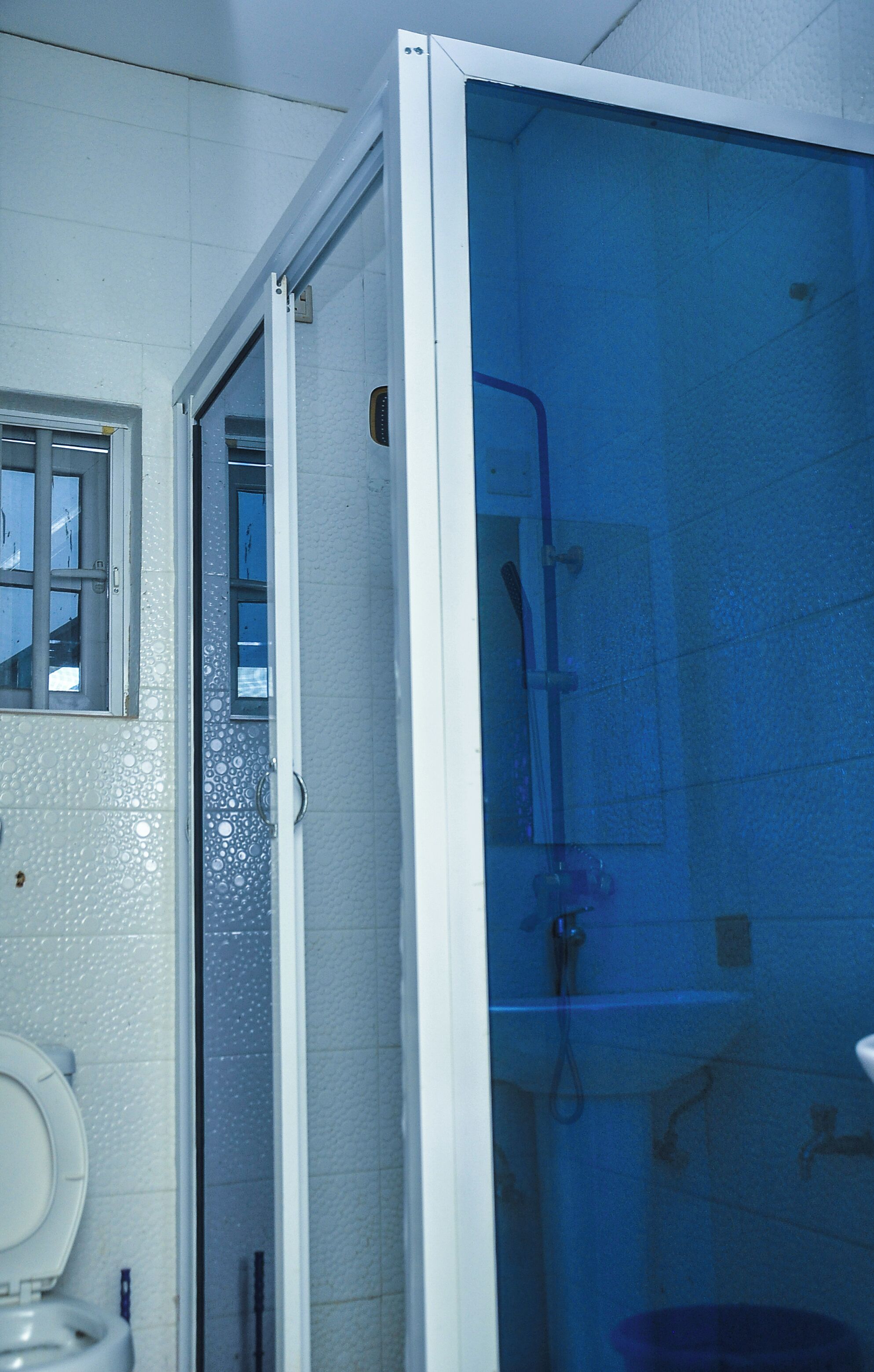 Een douche, pantoffels, handdoeken, zeep
