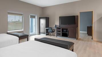 Premium bedding, desk, laptop workspace, blackout drapes