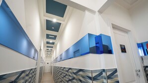A hotel hallway with a geometric patterned floor, a modern ceiling design, and a door labeled 'C6-7'. - MEDINA ART & LIFESTYLE NAPOLI CENTRO by ClaPa Group Dislocated Hospitality (Naples)