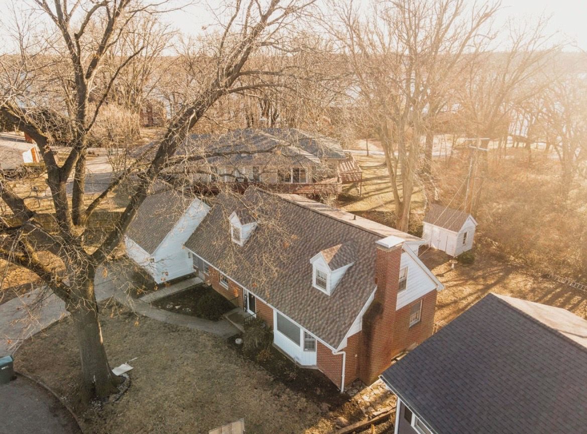 A residential property with a detached house, a garage, and a small shed.