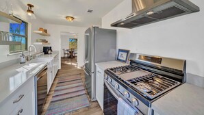 A modern kitchen with stainless steel appliances, a gas stove, and a built-in oven. - Morris Ranch (Fredericksburg)