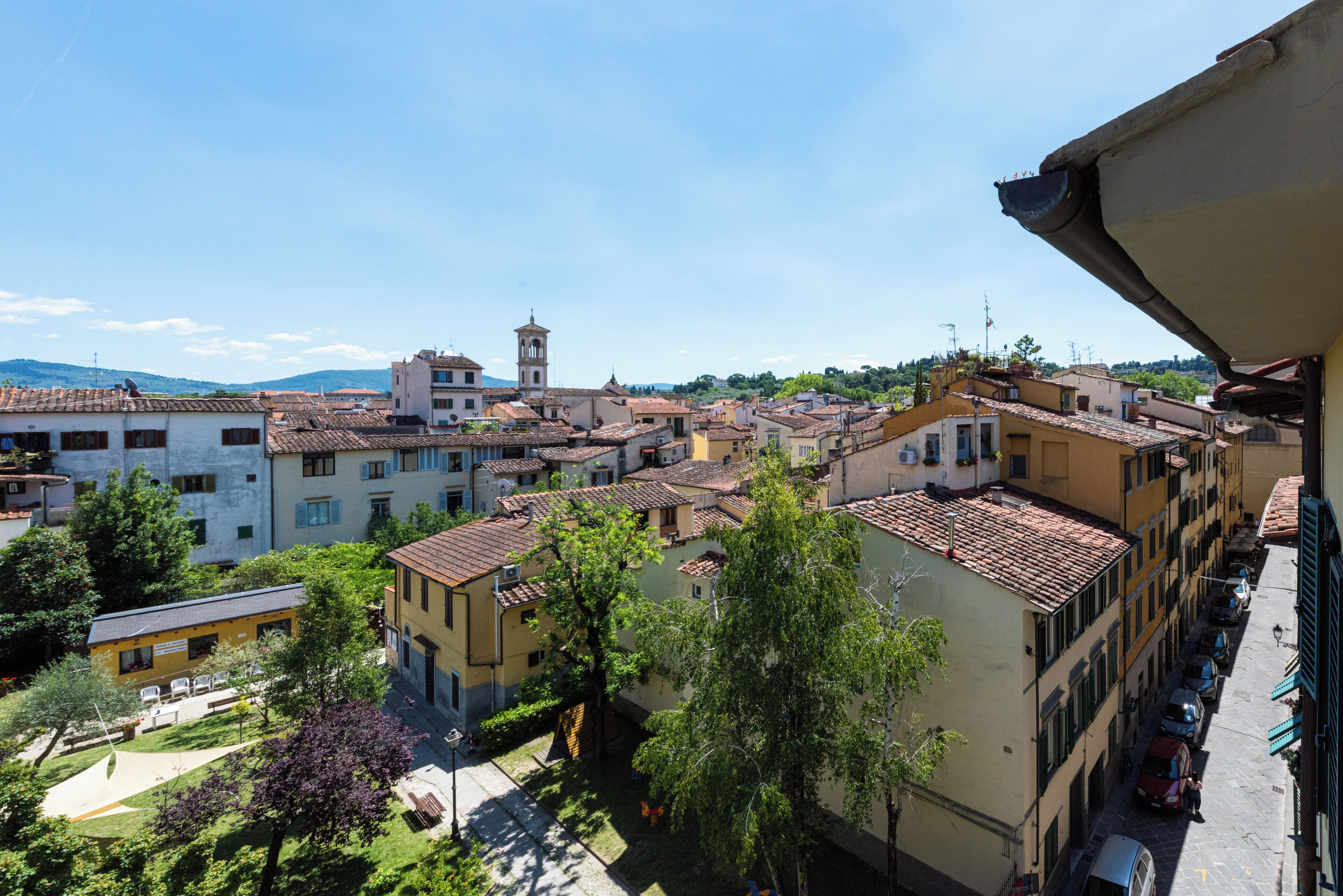 A town with buildings, a tower, and a street.
