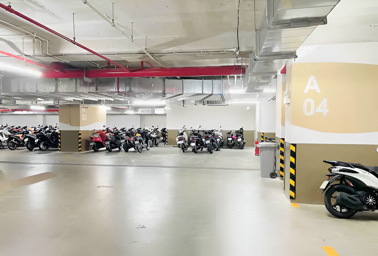 A multi-level parking garage with numerous motorcycles parked in rows.