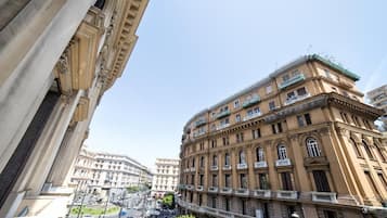 A multi-story building with classical architecture, featuring balconies and large windows.