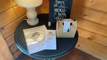 A table with a menu, a sign saying "There's the whole world at your feet," and a package on a wooden floor.