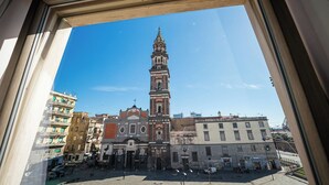 A view of a historic building with a tall tower, surrounded by other buildings. - P.C. BOUTIQUE DE GASPERI by ClaPa Group Dislocated Hospitality (Naples)