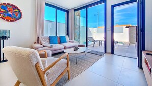 A modern living room with a sofa, armchair, and a coffee table. - Villa with private pool and Jacuzzi (San Javier)