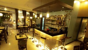 A restaurant with a bar area, multiple tables, and chairs. - Collection O Avitel Hotel near Osmena Highway, PNR Pasay Station, Metro Manila (Makati)