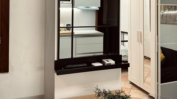 A modern kitchen with a built-in microwave, a small countertop, and a potted plant. - APARTMENT IN HISTORIC CENTER (Brescia)