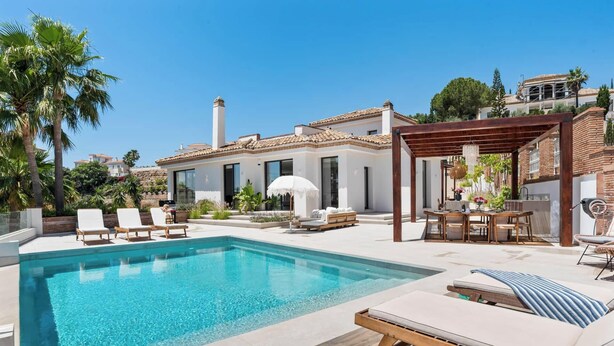 A modern villa with a swimming pool, outdoor seating, and a pergola. - Villa Sereno | Ref. #96 (Marbella)