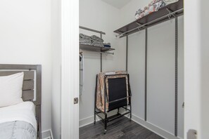 A bedroom with a bed, a wardrobe, and a drying rack. - 2BR Hollywood Apt w/ Rooftop deck & Stunning Views (Los Angeles)