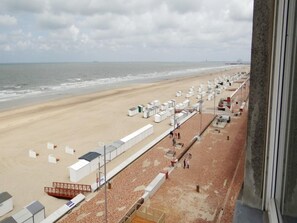 A beachside hotel with rows of white cabins, a sandy beach, and the ocean in the background. - Apartment in Wenduine With Stunning Sea Views (De Haan)