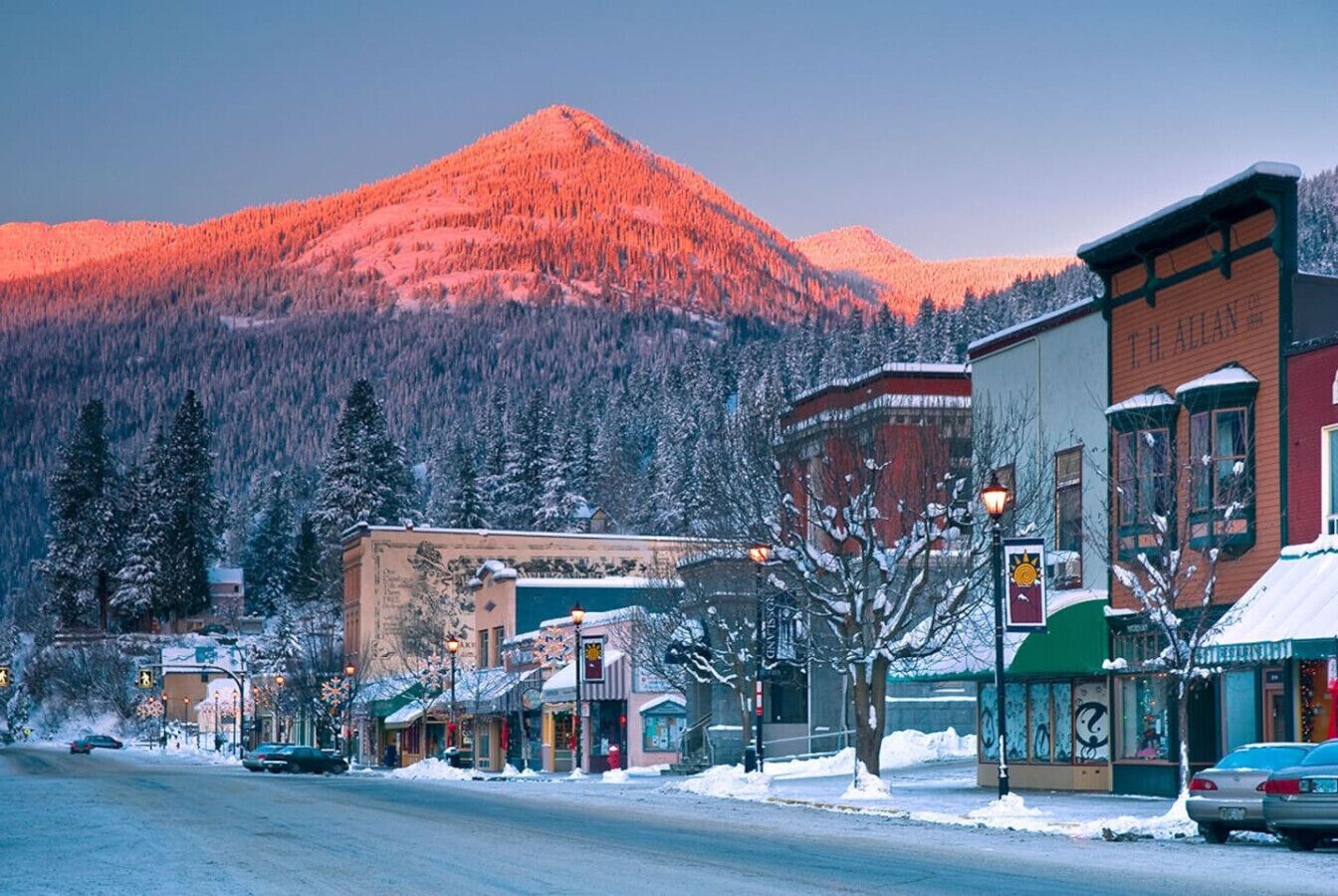 A snow-covered street with buildings, including a visible sign for 'T.H. ALLAN'.