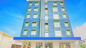 A modern building with a blue facade, multiple windows, and a visible entrance. - OYO 1144 1318 Residences (Manila)