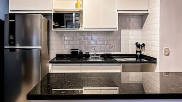 Fridge, microwave, coffee/tea maker, cookware/dishes/utensils