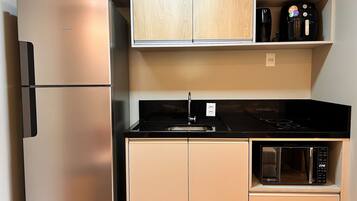 Fridge, microwave, coffee/tea maker, cookware/dishes/utensils