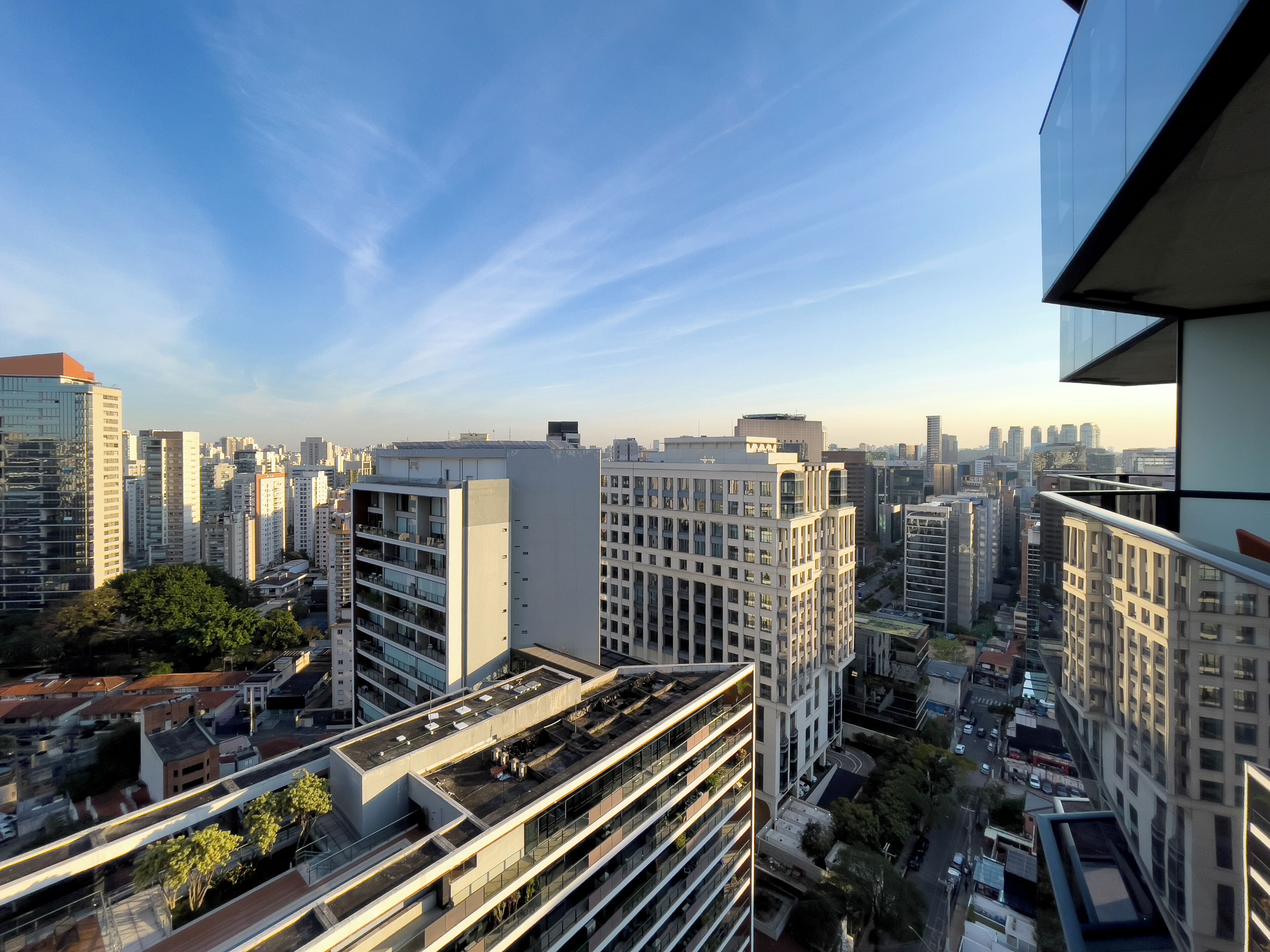 A high-rise building with multiple floors, large windows, and a flat roof.
