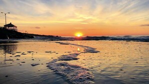 A beach at sunset with a path of foam leading to a gazebo. - Shore Thing · Walk to Beach · Sleeps 6 Guest Favorite Superhost (North Wildwood)