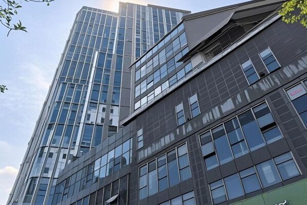 A multi-story building with a glass facade and a flat roof.
