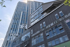 A multi-story building with a glass facade and a flat roof.