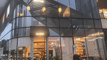 A modern building with a glass facade and a sign that reads 'Roth.'