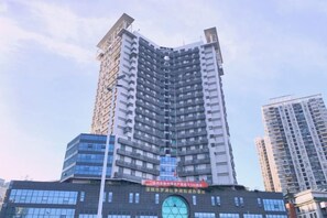 A multi-story building with a prominent clock on the facade, likely a hotel or office building.
