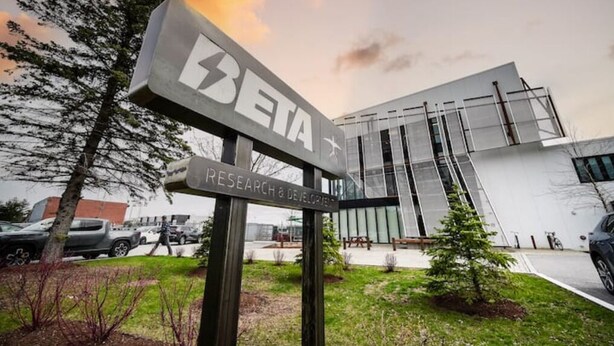 A sign for a building with the name "BETA" and a sign below it that reads "RESEARCH & DEVELOPMENT".