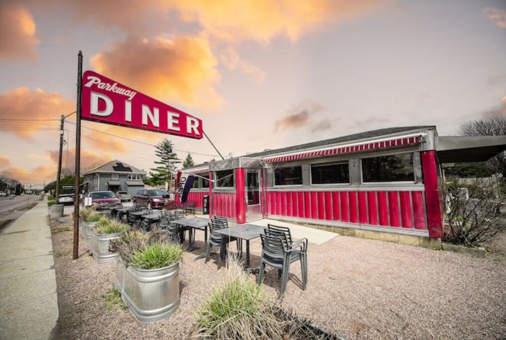A diner with a red exterior and a sign that reads "Parkway Diner."