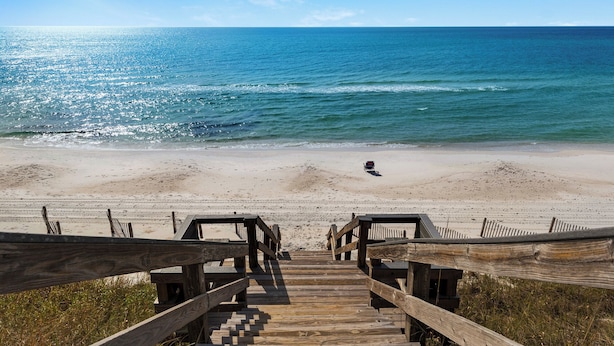 A wooden boardwalk leading to a beach with a wheelchair accessible path. - Sand Cliffs 108: Steps to Beach & Pool Access! (Panama City Beach)