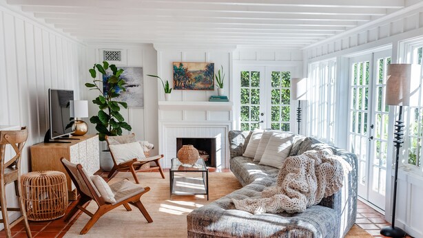 A living room with a sofa, chairs, a fireplace, and a television. - Buttterfly Beach Dream Cottage (Montecito)