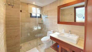 A modern bathroom with a glass-enclosed shower, a white toilet, and a large sink with a mirror above it. - 2BR 6 Guest Balcony in Portillo Close to Beach (Las Terrenas)