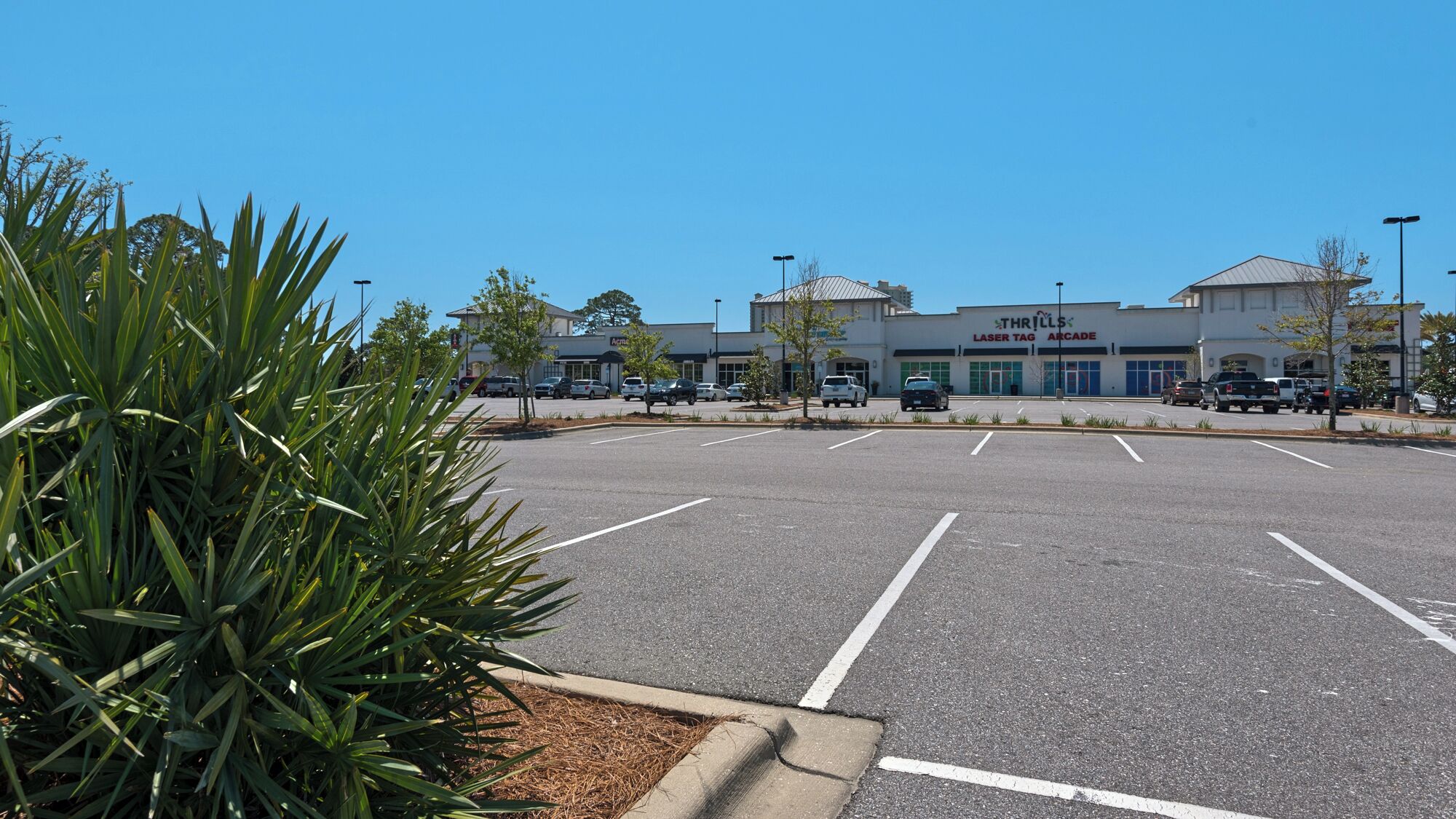 A parking lot with a building labeled "Thrills Laser Tag Arcade" in the background.