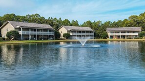 Stroll along the tranquil lakeside, surrounded by lush greenery and a picturesque fountain.