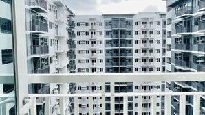 A high-rise residential building with multiple balconies and a modern architectural design. - Experience the Perfect Studio Retreat in Iloilo City (Iloilo City)