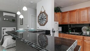 A modern kitchen with a large island, wooden cabinets, and pendant lighting. - 1bd 1bth , PYT , Airport , MPT (Fort Lauderdale)